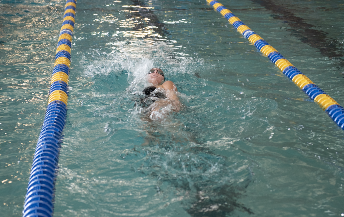 1.31.25 Junior Lucy Baker swimming backstroke in the 200 IM at Butte. 